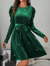 Green velvet puff sleeve dress with starry details and satin waistband