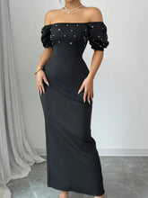 Black satin off-shoulder gown with pearl embellishments and puff sleeves