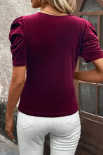 Burgundy velvet puff sleeve top with scoop neck, paired with white pants