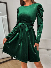 Green velvet puff sleeve dress with starry details and satin waistband