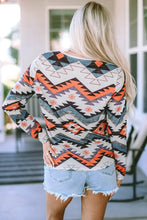 Geometric long sleeve V-neck T-shirt with Southwestern pattern and denim shorts