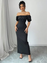 Black satin off-shoulder gown with pearl embellishments and puff sleeves