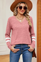 Women’s heathered pink long sleeve V-neck T-shirt with white striped sleeves