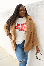 Woman in tan teddy bear coat and ripped jeans wearing Simply Love Chiefs Era short sleeve T-shirt