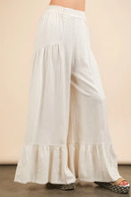 White flowing palazzo pants with ruffled tiers and very j palazzo elastic waist for comfort and style