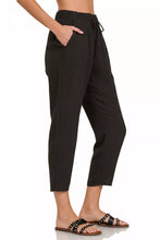 Black relaxed-fit woven crepe pants with elastic band waist and drawstring for comfortable casual wear