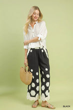 Black umgee wide leg pants with bold white hexagon print and scalloped hem for stylish casual wear