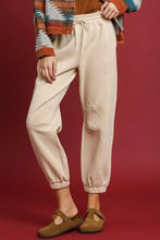 Cream-colored fleece jogger pants by umgee feature soft cotton fabric with drawstring waist allows and ribbed cuffs