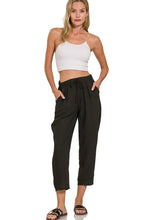 Black woven crepe cargo pants with elastic band waist drawstring and relaxed fit featuring side pockets by zenana