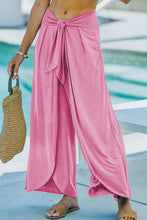 Pink knotted waist split leg relaxed pants with wide-leg flowing fabric and tied waistband for comfort and style