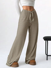 Striped wide leg drawstring pants in beige and dark brown with elastic waist and matching drawstring detail