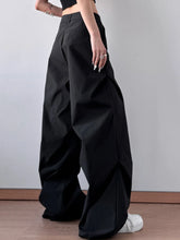 Black high-waisted wide leg oversized pants with a sleek structured design and subtle pleats care instructions included