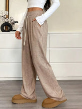 Beige casual drawstring waist wide leg pants with side pockets and comfortable sweatpant material