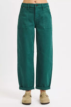 Emerald green high rise ankle cuffed wide-leg trousers with rolled cuffs and multiple pockets in a barrel style