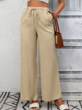 Beige drawstring high waist wide leg pants with elastic waist designed for comfortable everyday wear