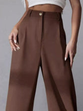 Brown high-waisted wide leg pleated pants with a sleek tailored design and subtle pleats for a polished look
