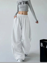 White oversized wide leg drawstring pants with elastic waistband and loose fit made of soft fabric for casual wear