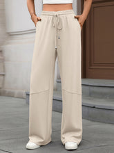 Beige drawstring high waist wide leg casual pants with subtle paneling for comfortable everyday wear