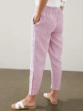 Full size striped pink and white cotton trousers with elastic waistband and side button detail for all-day comfort