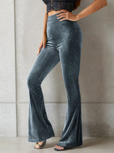 High-waisted ribbed velvet flare pants in dark blue featuring a luxurious vertical ribbed velvet flare texture