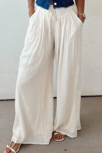 White flowing wide leg pants with tie waist pleated design and drawstring waist for comfortable fit