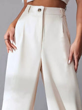 Cream-colored wide leg pleated pants with a high waist, tailored design, and single front button closure