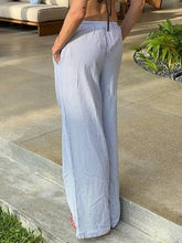 Light blue and white striped drawstring wide leg pants with a relaxed, flowing silhouette for comfortable wear