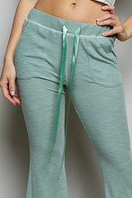 Mint green pol drawstring textured ribbed knit pants with satin drawstrings and side pockets in ribbed knit fabric