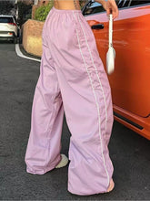 Light purple elastic waist wide leg pants with white side stripes designed for comfort and style