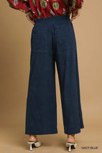 Navy blue umgee wide-leg corduroy pants with relaxed fit, elastic waistband, and two front pockets
