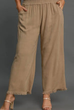 Beige linen blend wide leg pants with elastic waistband and frayed hems in plus size by umgee