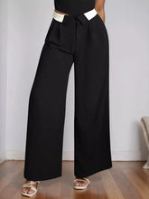 Black wide leg pants with a white waistband and tie closure designed for a stylish and comfortable fit