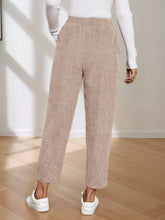Beige corduroy elastic waist cropped pants with a relaxed tapered fit and elastic waistband for comfort