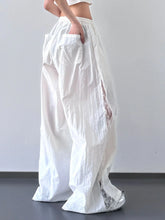 White flowing wide-leg pants with elastic waist sheer lace panels and relaxed fit for comfortable wear