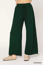 Dark green umgee wide leg pants with elastic drawstring waistband designed for comfortable casual wear
