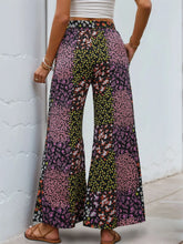 Floral high rise wide leg pants with pink green and black patchwork floral pattern and small blossoms design