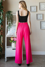 Bright pink wide-leg Heimish tie pants with paperbag waistband and subtle vertical pleats plus size pants offer