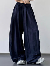 Dark navy wide-leg pants with elastic waistband and loose fit suitable for machine wash care instructions