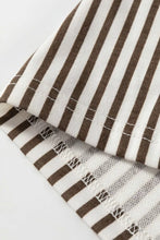 Brown and white striped fabric with soft woven texture on stripe elastic high waist pocketed loose pants