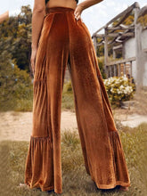 Copper-colored velvet high waist wide leg pants with tiered ruffle detailing at the hem