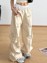 Beige cargo wide leg pants with drawstring bow tie waist and multiple side pockets in a relaxed fit