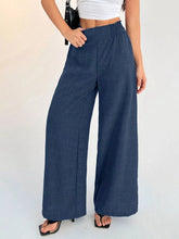 Navy blue elastic waist wide leg pants with a high-waisted elasticated waistband and vertical seam detailing