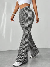 Black and white houndstooth high waisted flare pants featuring a bold pattern and flared silhouette for stylish wear