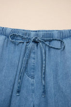 Light blue chambray pants with elastic waistband drawstring and ruffled hem wide leg design