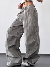 Gray drawstring wide leg cargo pants with subtle vertical ribbing and a comfortable adjustable waist design