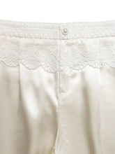 Cream satin wide-leg pants with lace waist trim and pearl button at the waistband for elegant comfort