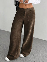 Brown corduroy wide leg pants with high waist and front pockets featuring corduroy texture ideal for ankle boots