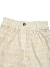 Cream-colored lace decorative button wide leg pants with intricate pattern and single brown button at waistband