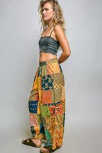Pol printed patchwork wide leg pants in vibrant orange teal green and gold with elastic waistband and adjustable side drawstring