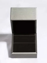 Open grey velvet-lined box with 1 carat moissanite 925 sterling silver earrings